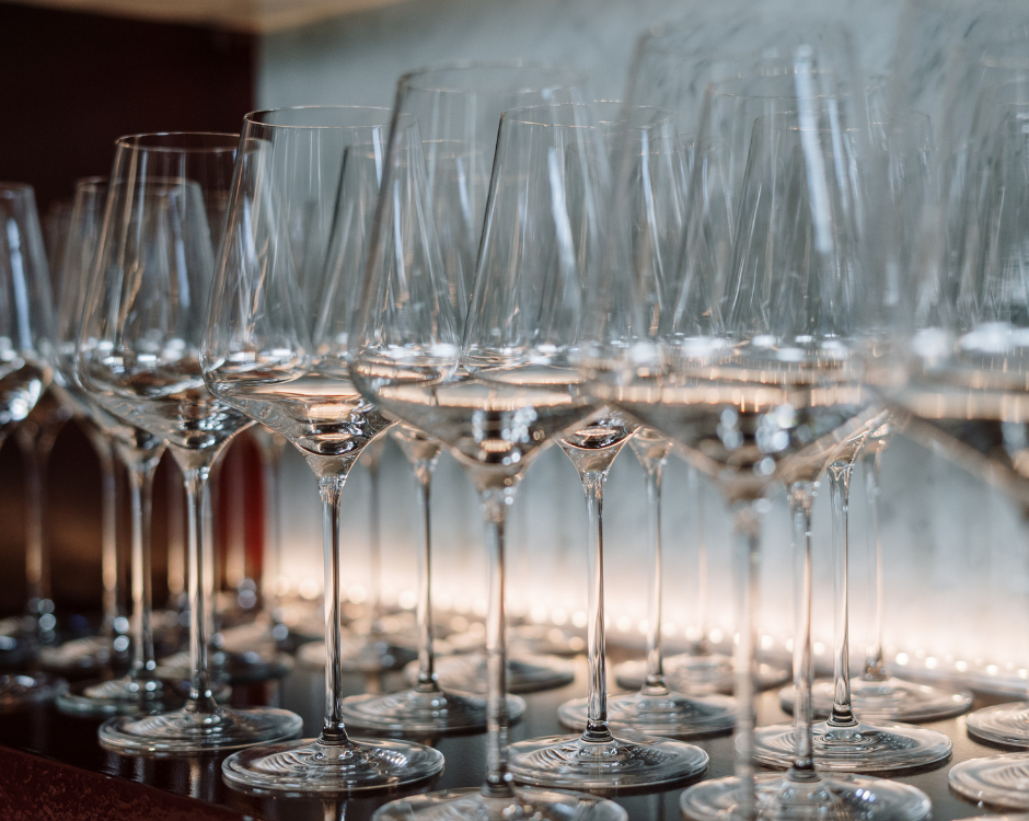 several stemmed wine glasses in a row